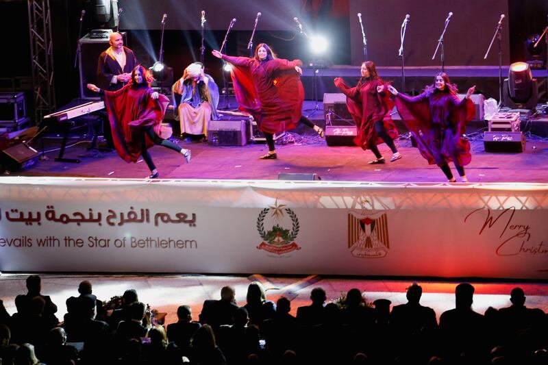 People perform during events to mark the lightning of the Christmas tree at Manger Square, outside the Church of the Nativity in Bethlehem. Reuters