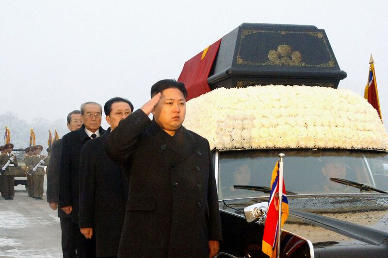 Kim Jong-un salutes besides the convoy carrying the body of his father and late leader Kim Jong-il at Kumsusan Memorial Palace in Pyongyang in December 2011. KCNA / AFP