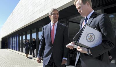 US Secretary of State John Kerry (C) accompanied by aide Jason Meininger leaves a meeting with European Union Ministers of Foreign Affairs at the National Gallery of Art in Vilnius, Lithuania, on September 7, 2013.  Kerry traveled to Europe to court international support for a possible strike on the Syrian regime for its alleged use of chemical weapons while making calls back home to lobby Congress where the action faces an uphill battle.   AFP PHOTO / POOL/ SUSAN WALSH (Photo by SUSAN WALSH / POOL / AFP)