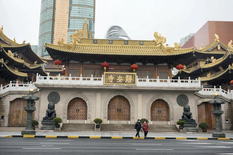 SHANGHAI, CHINA - MARCH 09: Pedestrians wearing protective masks walk by closed Jing'an Temple, one of the most famous Buddhist temple of Shanghai on March 09, 2020 in Shanghai, China. The Chinese government has temporarily closed all of the country‚Äôs places of worship in an effort to contain the COVID-19 respiratory coronavirus since January 24. Twenty-one of mainland China's 31 regions have lowered emergency response levels on the flu-like epidemic by March 1, allowing greater movement of people and goods and a recovery in business activity. Since the outbreak began in December last year, more than 80,000 cases have been confirmed in China, with the death toll rising to more than 3,100. As of today, the number of cases of new coronavirus COVID-19 being treated in China dropped to approximately 19,000 in China. The World Health Organization (WHO) declared to raises coronavirus threat assessment to ‚Äúvery high‚Äù globally by the end of February. (Photo by Yifan Ding/Getty Images)