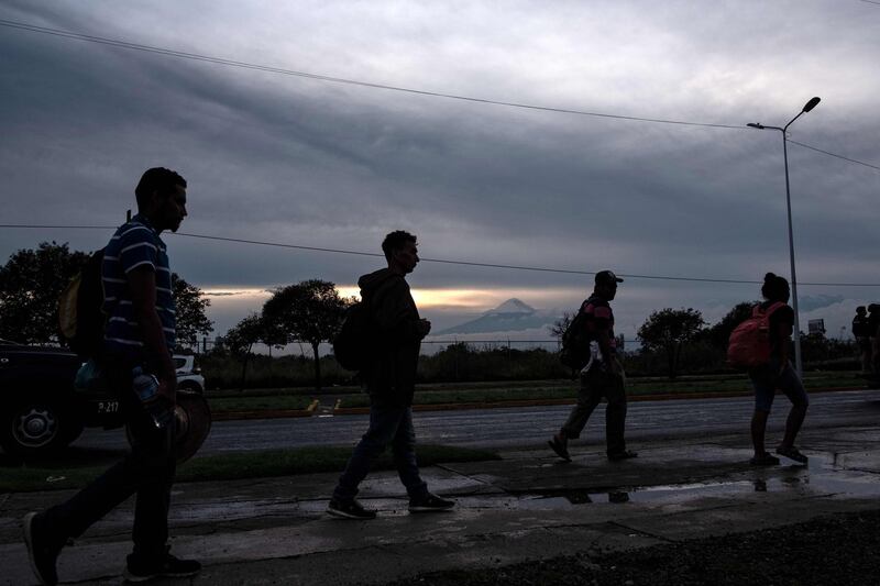 Migrants head to a shelter after arriving in Puebla, Mexico. AFP