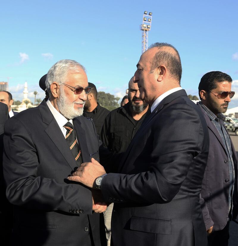 Libyan Foreign Minister Mohamed Taher Siala receives his Turkish counterpart Mevlut Cavusoglu upon his arrival at Mitiga International Airport near the Libyan capital Tripoli. AFP
