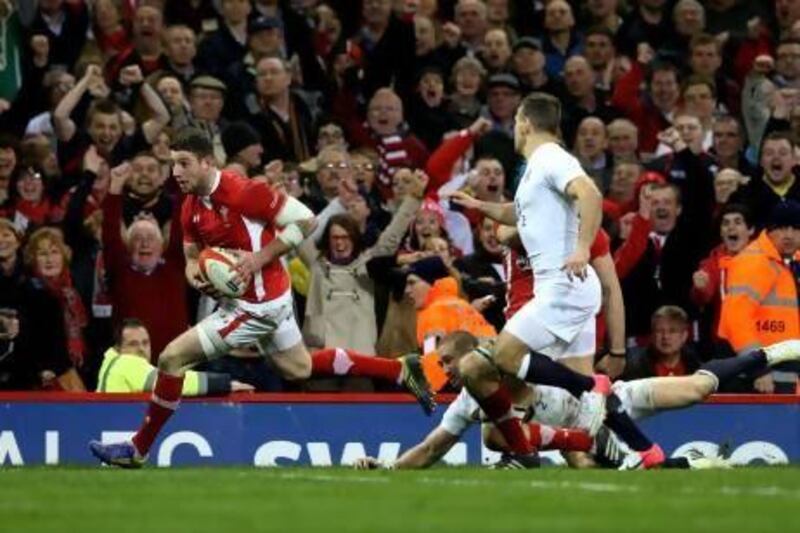 Alex Cuthbert of Wales goes past Mike Brown and Danny Care of England at the Millennium Stadium. Alex Livesey / Getty Images