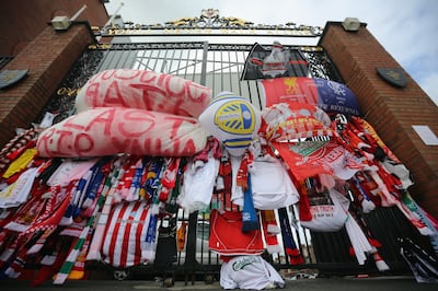Tributes to the victims of the Hillsborough disaster adorn the Hillsborough memorial and the Bill Shankly gates at Anfield stadium in Liverpool. Getty Images