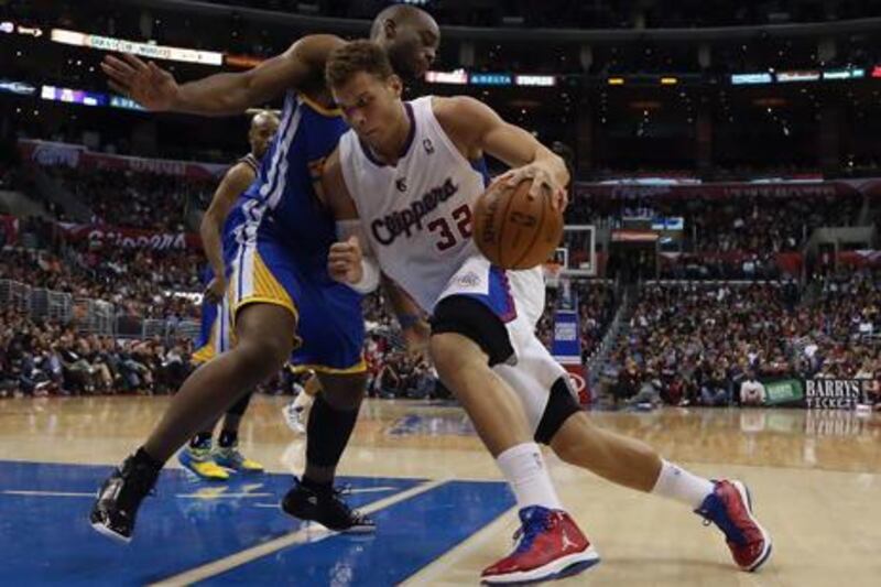 Los Angeles Clippers' Blake Griffin looks for a way past Carl Landry of the Golden State Warriors.