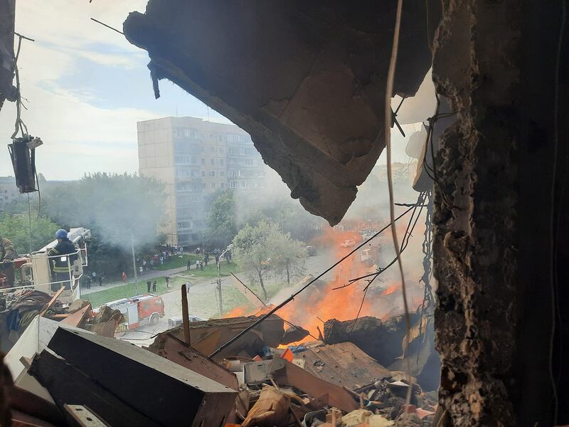 A fire in a nine-storey residential building partially destroyed as a result of Russian missile strike in Kryvyi Rih. AFP