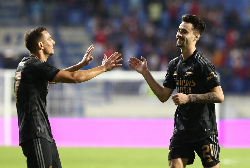 Fabio Vieira celebrates scoring Arsenal's third goal with Cedric Soares. Reuters