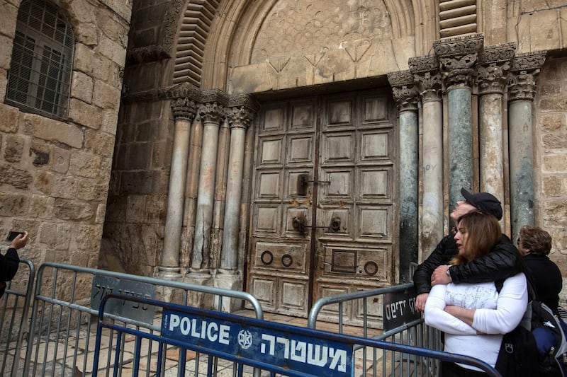 Christian pilgrims by the closed Church of the Holy Sepulchre in the Old City of Jerusalem on Monday February 26,2018.The Church of the Holy Sepulchre  remained closed for a second day after church leaders in Jerusalem closed it to protest against Israeli's announced plans by the cityÕs municipality earlier this month to collect property tax (arnona) from church-owned properties on which there are no houses of worship.
(Photo by Heidi Levine for The National).