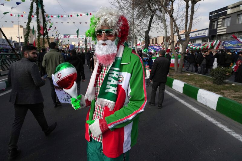 A man wears a jacket in the colours of the Iranian flag. AP
