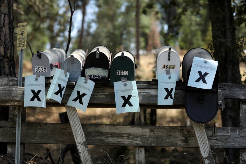 Evacuation notices are taped to mailboxes as the Oak Fire burns in Mariposa County, California. Reuters