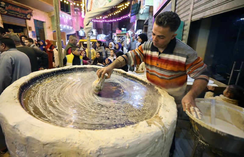 An Egyptian baker prepares Knafeh ahead of Ramadan in Giza, Egypt. EPA