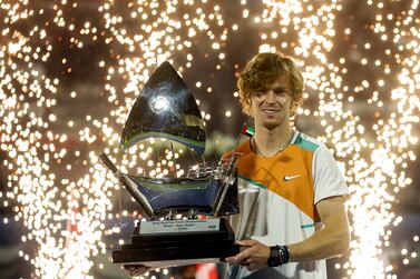 Andrey Rublev of Russia poses with the winner's trophy after winning the final match of the ATP Dubai Duty Free Tennis Championship in the Gulf emirate on February 26, 2022.  (Photo by Karim SAHIB  /  AFP)
