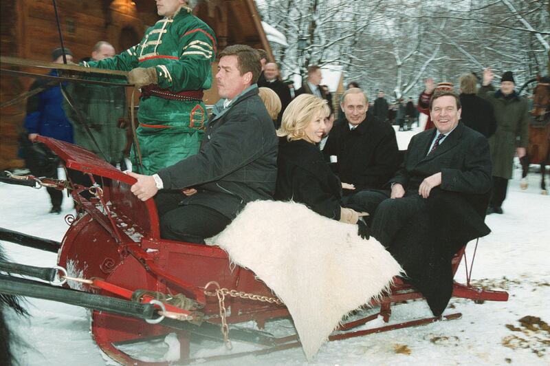 Gerhard Schroeder, far right, rides in a Russian sleigh with Vladimir Putin, second right, on a visit to Moscow in 2001.