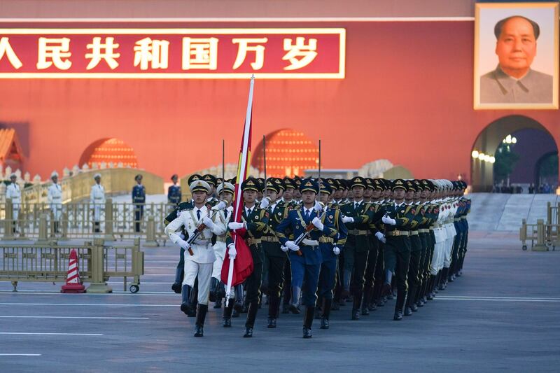 In Tiananmen Square in Beijing, an honour guard marches to a flag-raising ceremony on October 1 to mark the 73rd anniversary of the founding of the People's Republic of China. AP