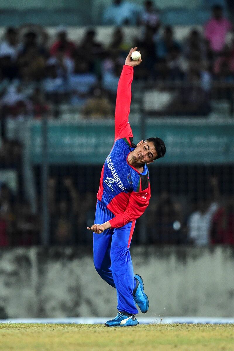 Afghanistan's Mujeeb Ur Rahman delivers a ball during the third match between Afghanistan and Bangladesh in the T20 Tri-nations cricket series at the Sher-e-Bangla National Stadium in Dhaka on September 15, 2019. (Photo by MUNIR UZ ZAMAN / AFP)