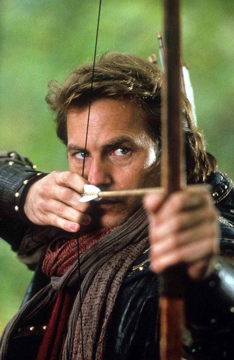 Kevin Costner aiming bow and arrow in a scene from the film 'Robin Hood: Prince Of Thieves', 1991. (Photo by Warner Brothers/Getty Images)