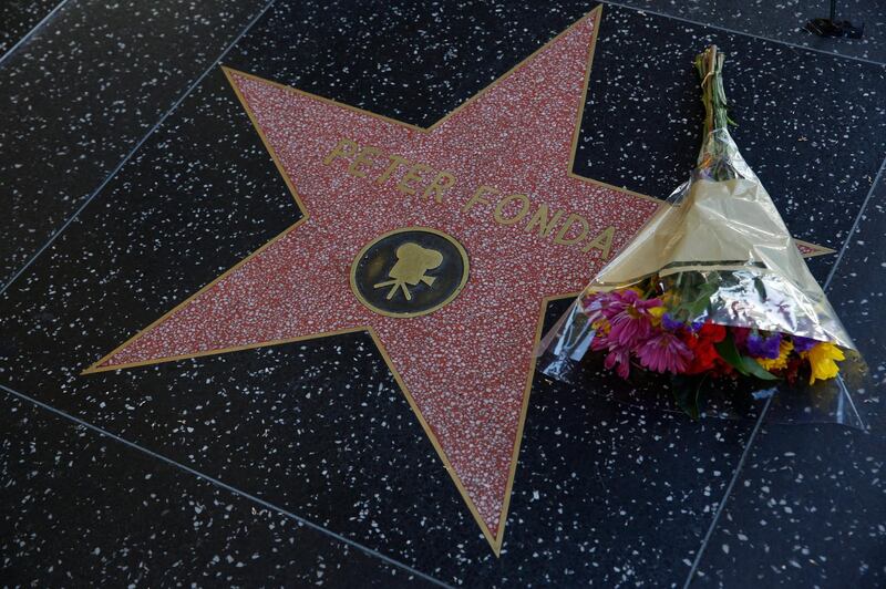 Fans place flowers on the Walk of Fame star of Peter Fonda on Friday, August 16, in Los Angeles. AP Photo.