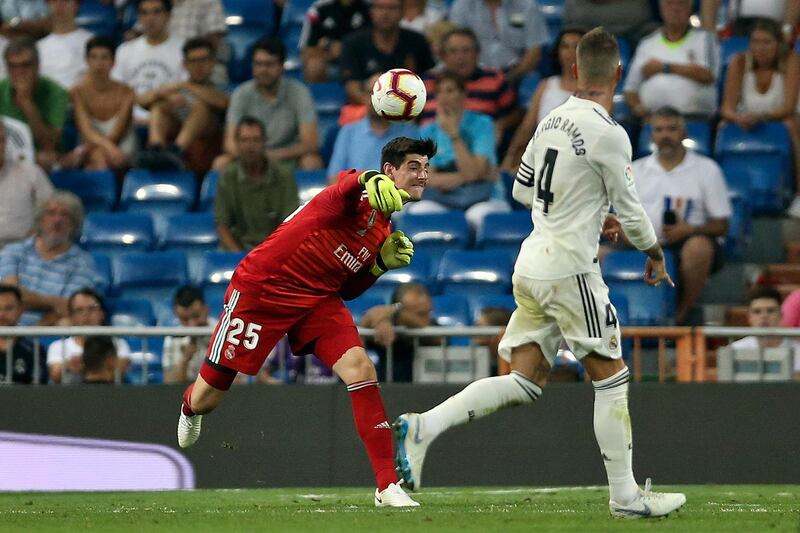 Real Madrid goalkeeper Thibaut Courtois, left, throws the ball. AP Photo