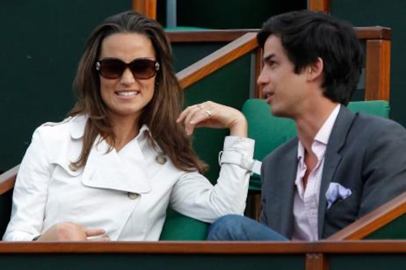 The sister of Kate Middleton, Pippa Middleton and a friend attend a match during the French Open tennis championship at the Roland Garros stadium, on May 30, 2011, in Paris.   AFP PHOTO