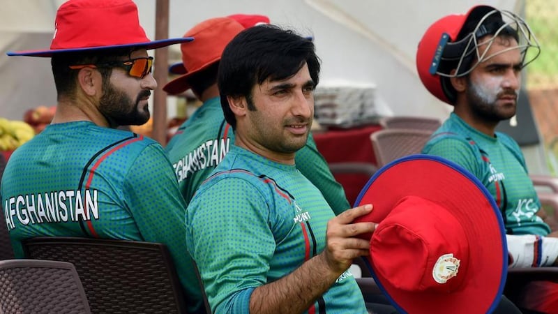 Afghanistan cricket team captain Asghar Stanikzai, centre, takes a break during a practise session at a cricket stadium in Greater Noida, India. AFP