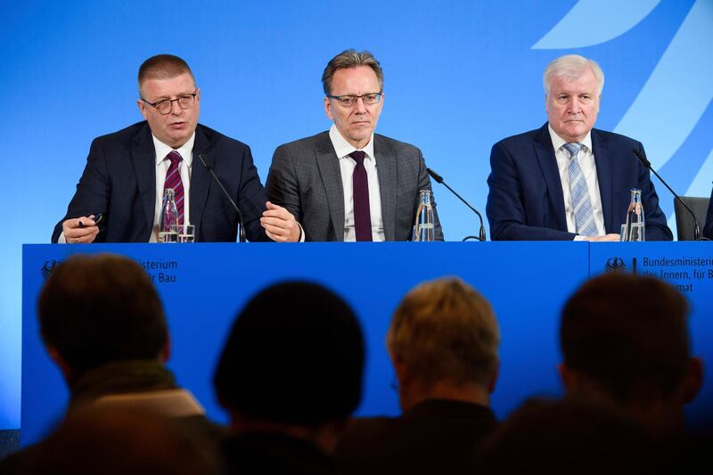 From left, Thomas Haldenwang, President of the Federal Office for the Protection of the Constitution, Holger MÃ¼nch, President of the Federal Office of Criminal Investigation, and German Interior Minister Horst Seehofer attend a press conference in Berlin, Germany, Tuesday, Dec. 17, 2019. Seehofer said the Federal Criminal Police Office and the Federal Intelligence Agency would each add 300 positions dedicated to investigating and preventing far-right crimes, without weakening efforts focused on far-left crimes and Islamic extremism. (Gregor Fischer/dpa via AP)