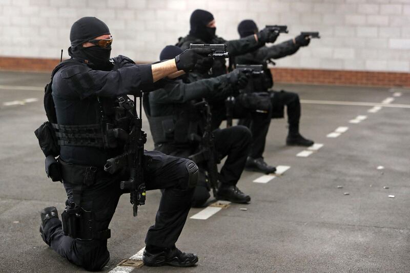 Police firearms officers hold their weapons as they take part in a live firing training exercise. AFP