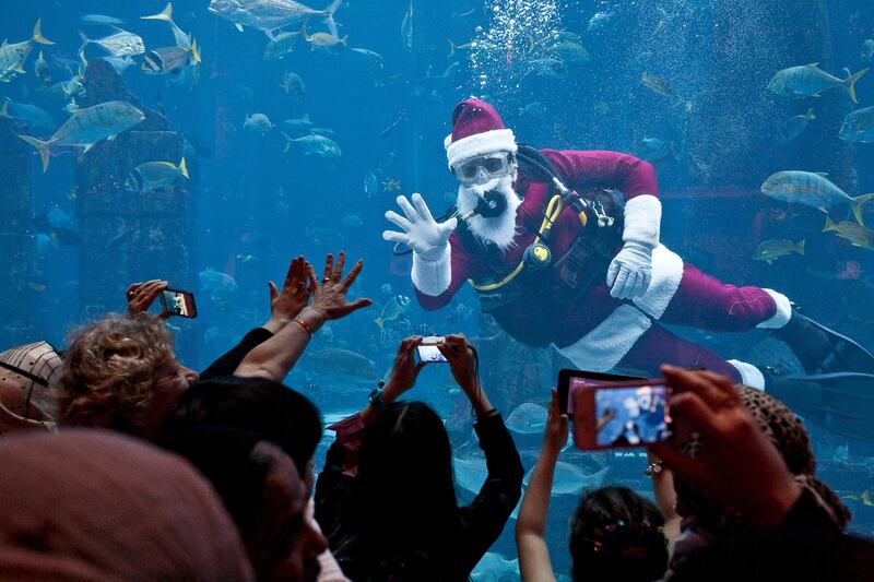 DUBAI, UNITED ARAB EMIRATES,  December 25, 2012. Renato Roman (Philippines) dressed in a special Santa scuba suit entertains guests at the Poseidon Court, Ambassador Lagoon at Atlantis. (ANTONIE ROBERTSON / The National)