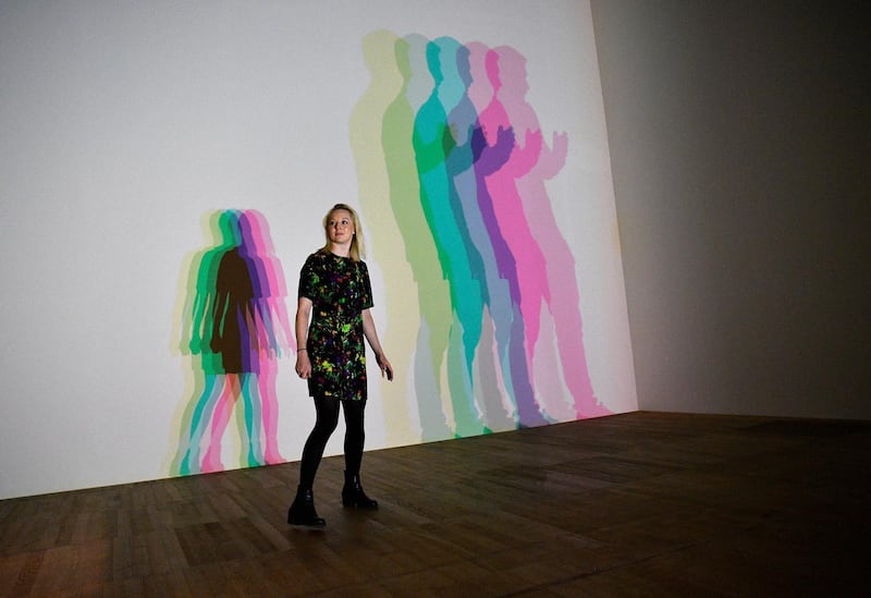 A woman poses with Danish-Icelandic artist Olafur Eliasson's work 'Your Uncertain Shadow' (2010) at the Tate Modern in London, Britain, 09 July 2019. Photo: EPA