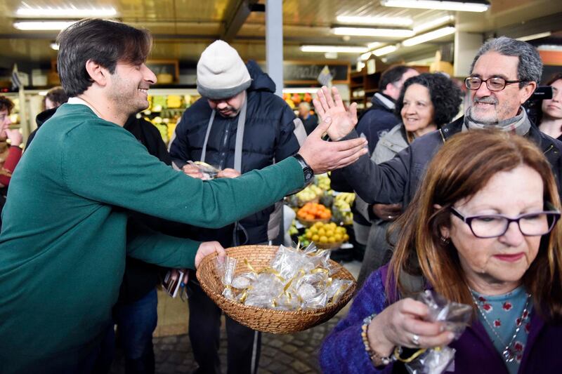 Syrian Ahmed Ahjam hands out samples at the opening of his Middle Eastern pastry shop at the Mercado Agricola in Montevideo, Uruguay, Monday, Aug. 13, 2018. Heâ€™s one of six former detainees accepted by Uruguay in 2014 after U.S. authorities decided they werenâ€™t threats but couldnâ€™t be sent to their homelands. Ahjam and the others have struggled to adapt to the South American country. But the former jeweler from Syria says heâ€™s learned to make sweets with recipes from his sisters and heâ€™s been earning money selling them at fairs and private events. (AP Photo/Matilde Campodonico)