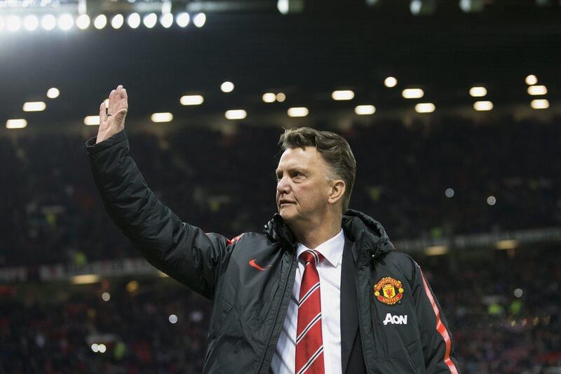 Manchester United manager Louis van Gaal waves to supporters before his side's Premier League win over Stoke City on Tuesday at Old Trafford. Jon Super / AP / December 2, 2014 
