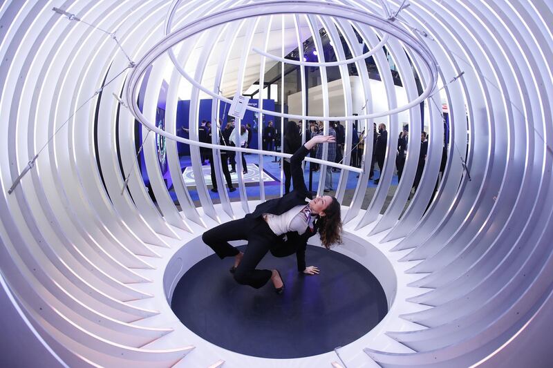 An attendee dances inside the 'orbiting' 360-degree video capsule at the Samsung pavilion during day two of the Mobile World Congress in Barcelona. Bloomberg