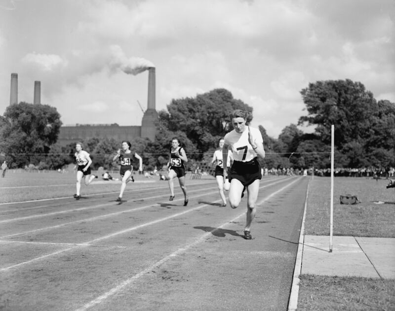 British athlete Heather Armitage running in Battersea Park, with the chimneys of the famous power station behind her in 1952. Getty Images