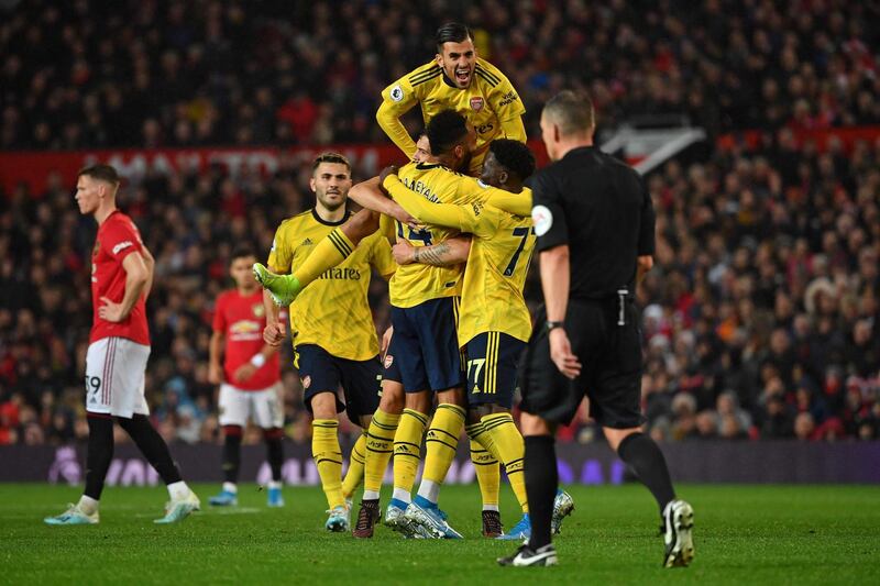 Arsenal's Gabonese striker Pierre-Emerick Aubameyang (C) celebrates with teammates after scoring their first goal, decision of off-side overturned by VAR (Video Assistant referee) during the English Premier League football match between Manchester United and Arsenal at Old Trafford in Manchester, north west England, on September 30, 2019. RESTRICTED TO EDITORIAL USE. No use with unauthorized audio, video, data, fixture lists, club/league logos or 'live' services. Online in-match use limited to 120 images. An additional 40 images may be used in extra time. No video emulation. Social media in-match use limited to 120 images. An additional 40 images may be used in extra time. No use in betting publications, games or single club/league/player publications.
 / AFP / Paul ELLIS / RESTRICTED TO EDITORIAL USE. No use with unauthorized audio, video, data, fixture lists, club/league logos or 'live' services. Online in-match use limited to 120 images. An additional 40 images may be used in extra time. No video emulation. Social media in-match use limited to 120 images. An additional 40 images may be used in extra time. No use in betting publications, games or single club/league/player publications.
