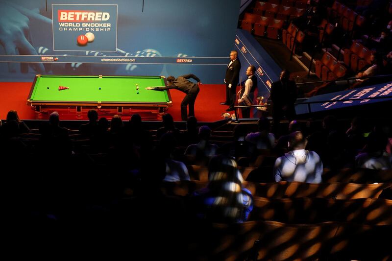 Reigning champion Ronnie O'Sullivan plays a shot during his first-round match against Mark Joyce on Day 1 of the World Snooker Championships at The Crucible, Sheffield. The tournament sees spectators return to sport in the UK after being played behind closed doors due to Covid-19. PA