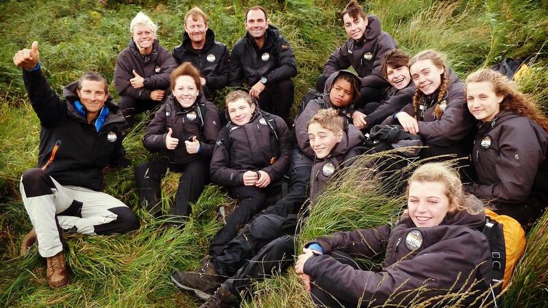 Bear Grylls with the young participants of his Survivor School TV series, which begins on Discovery Family HD on September 14. Courtesy OSN