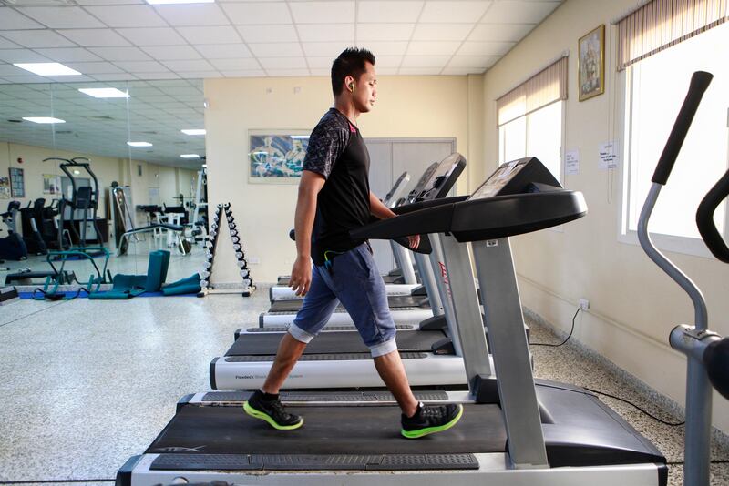 DUBAI, UAE. April 2, 2015 - Filipino Ricarte Ricardo walks on a treadmill at the gym in Oasis Village in Dubai, April 2, 2015. (Photos by: Sarah Dea/The National, Story by: Nadeem Hanif, News)
 *** Local Caption ***  SDEA020315-startwalking04.JPG