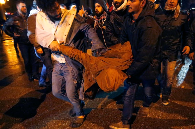 Anti-government protesters carry their friend who was injured by rubber bullet while clashing with the riot police, during ongoing protests against the political elites who have ruled the country since decades, in Beirut. AP Photo