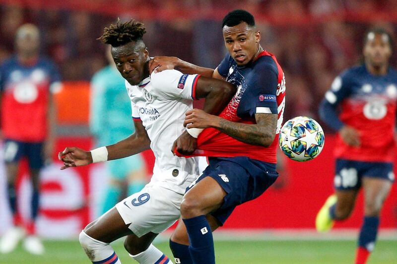Chelsea's Tammy Abraham, left, fights for the ball with Lille's Gabriel. AP Photo