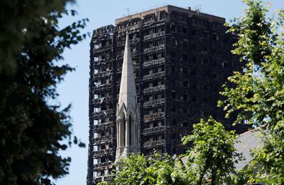 FILE PHOTO: The spire of the Notting Hill Methodist Church stands in front of Grenfell Tower, destroyed in a catastrophic fire, in the Royal Borough of Kensington and Chelsea, in London, Britain July 2, 2017.  REUTERS/Peter Nicholls/File Photo