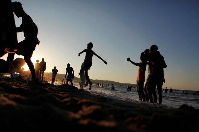 People enjoy the beach on a hot day in Tunis, Tunisia. Reuters