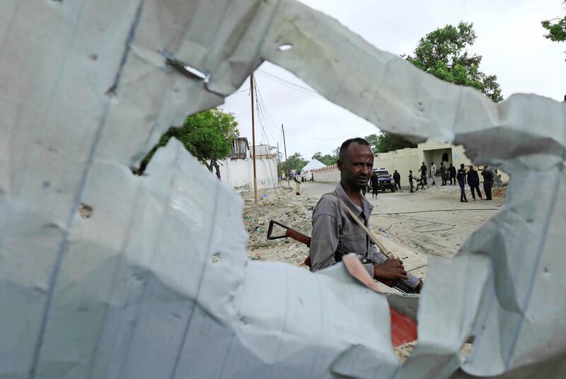 A Somali policeman walks at the scene after a suicide car bomber drove into a checkpoint outside the port in Mogadishu, Somalia. Reuters