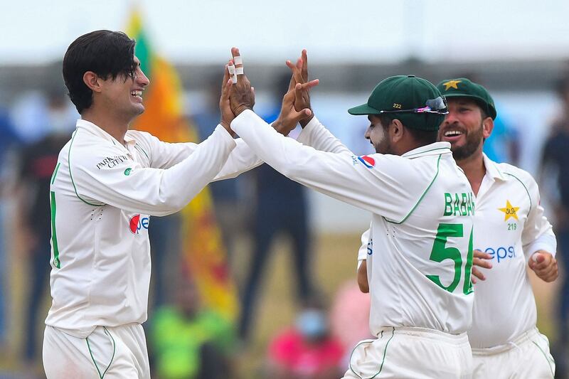 Pakistan's Naseem Shah, left, celebrates with captain Babar Azam after taking the wicket of Sri Lanka's Dinesh Chandimal. AFP
