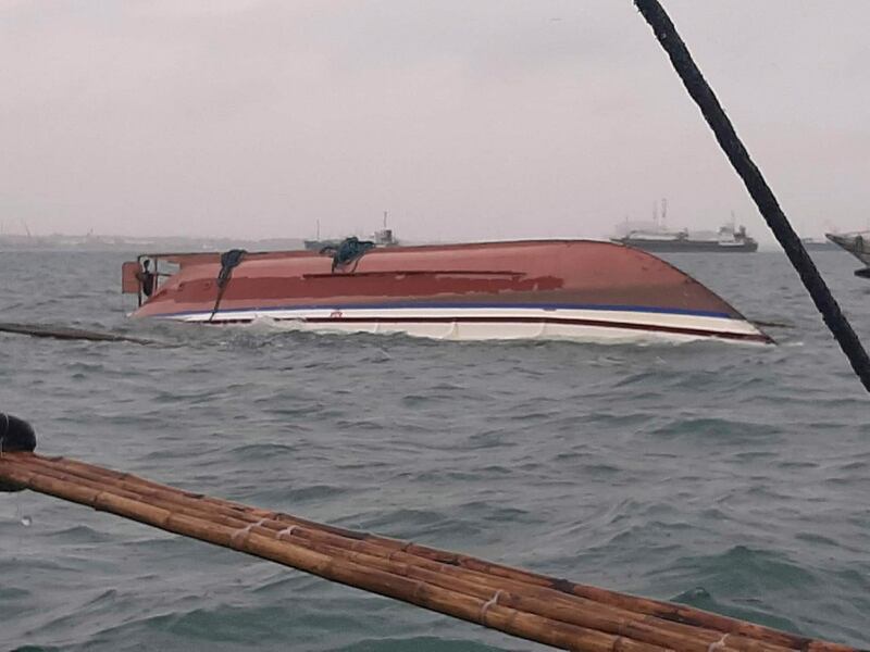 An upturned boat pictured in waters between Iloilo and Guimaras. EPA / Philippines Red Cross