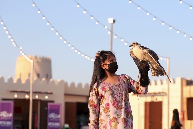 Alia Obaid with her falcon at Al Dhafra Festival. The Abu Dhabi event aims to preserve and share Emirati culture. Khushnum Bhandari / The National