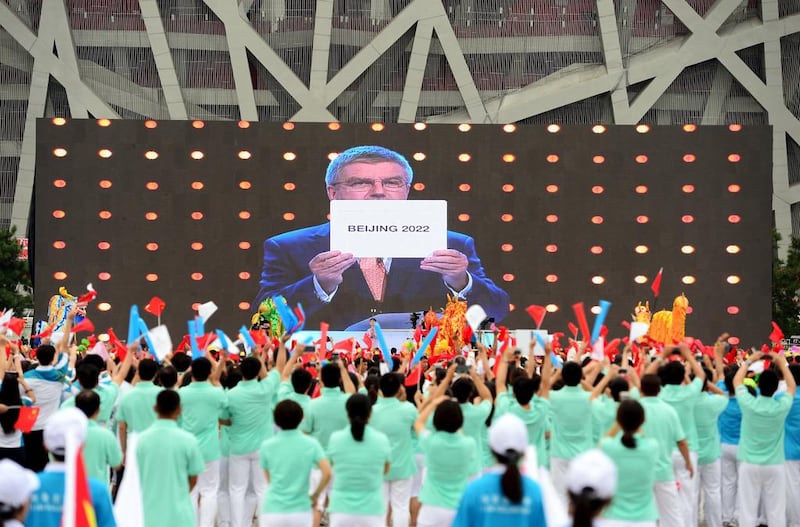 People cheer as they watch on a screen the IOC announcing Beijing as the winner city for the 2022 Winter Olympics bid. Stringer / Reuters