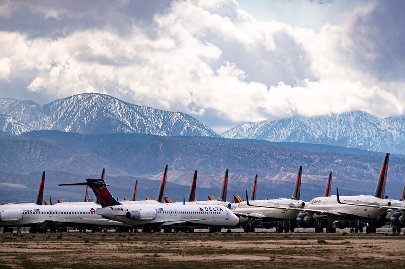 epaselect epa08325532 Delta Airlines planes are parked at the Southern California Logistics Airport among hundreds of other airplanes amid the coronavirus pandemic in Victorville, California, USA, 26 March 2020. In order to limit the spread of the COVID-19 coronavirus, big US carriers have announced plans to slash domestic flights by 30 percent and international flights by 75 percent, and some of the aircraft serving those routes may never return to service.  EPA-EFE/ETIENNE LAURENT