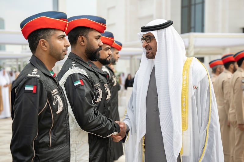Sheikh Mohamed greets a member of Al Forsan aerobatic team