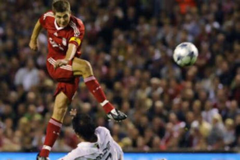 Liverpool's Steven Gerrard shoots past Liege's Marcos Camozzato at Anfield.
