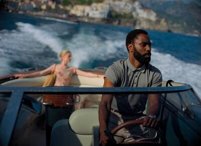 This image released by Warner Bros. Entertainment shows Elizabeth Debicki, left, and John David Washington in a scene from "Tenet."  (Melinda Sue Gordon/Warner Bros. Entertainment via AP)