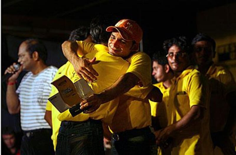 Mohsin Khan receives a hug from a colleague after he and teammate Mukesh Manilal, far right, won the contest.